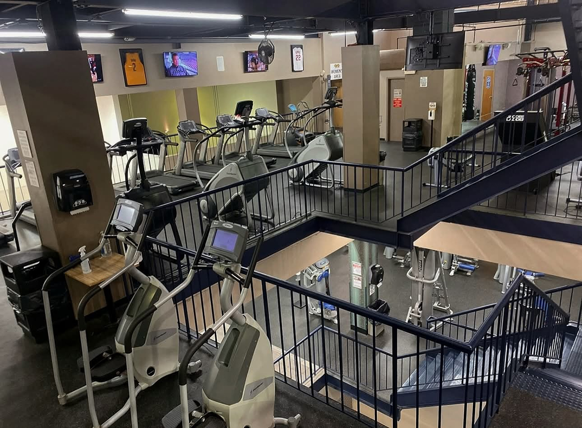 Row of high-performance treadmills and elliptical machines at Cleveland Fitness Club