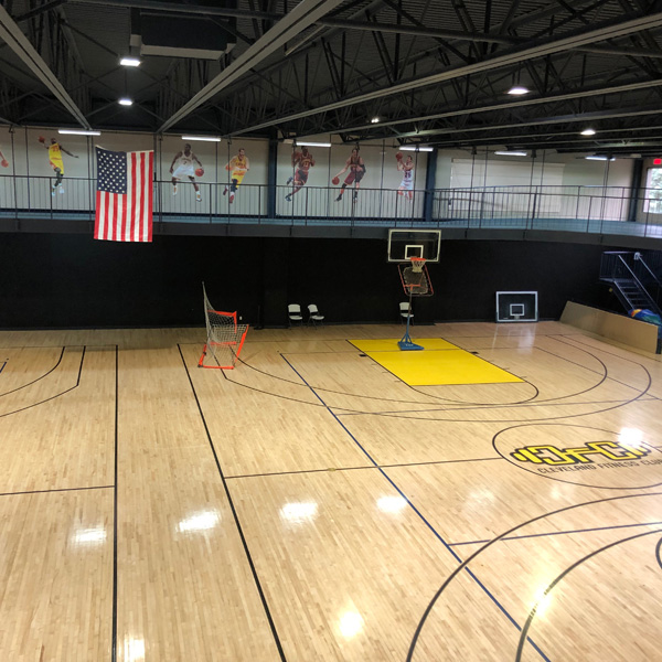 Enclosed racquetball court with white walls and court lines at Cleveland Fitness Club