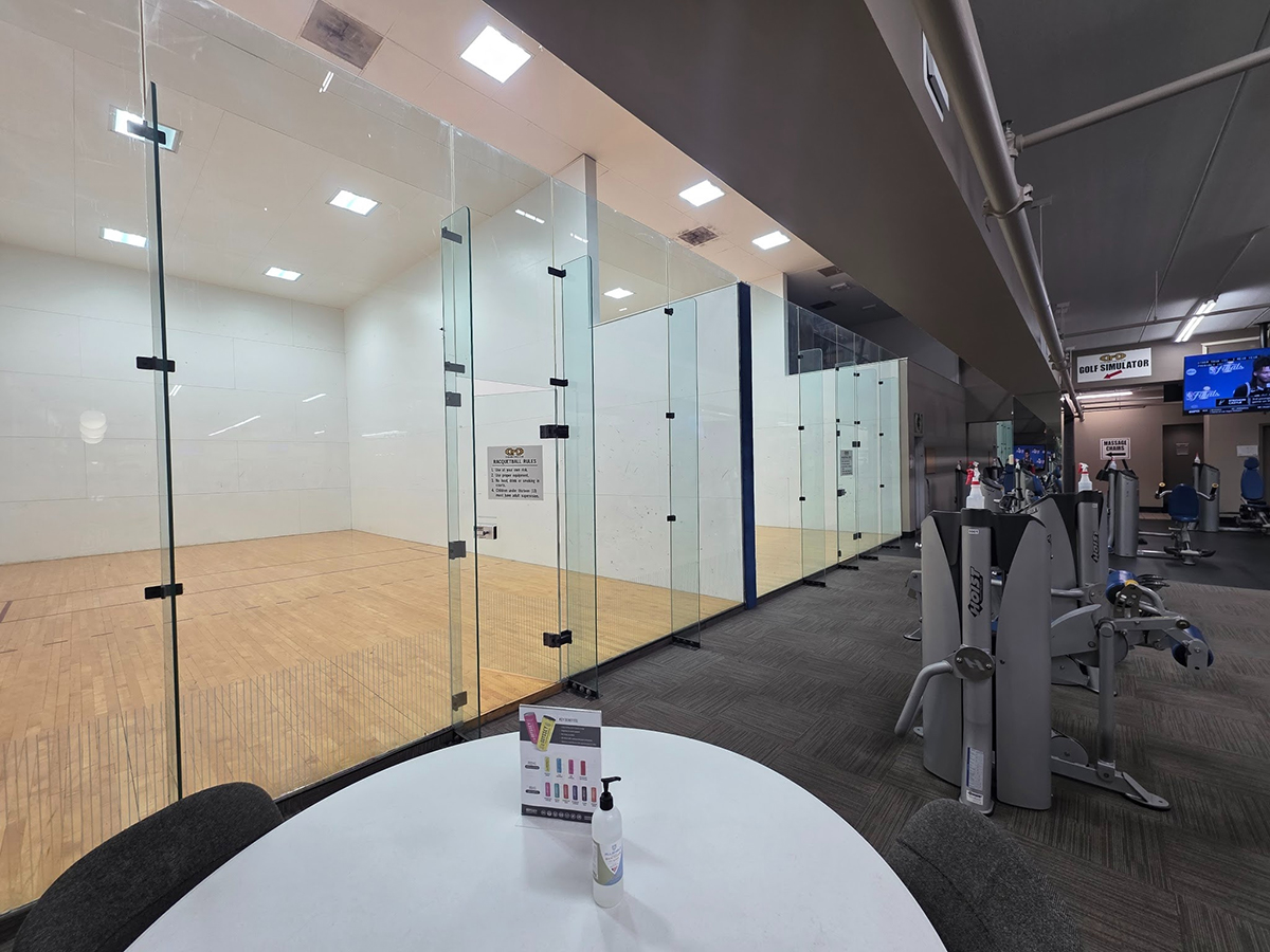 Enclosed racquetball court with white walls and court lines at Cleveland Fitness Club