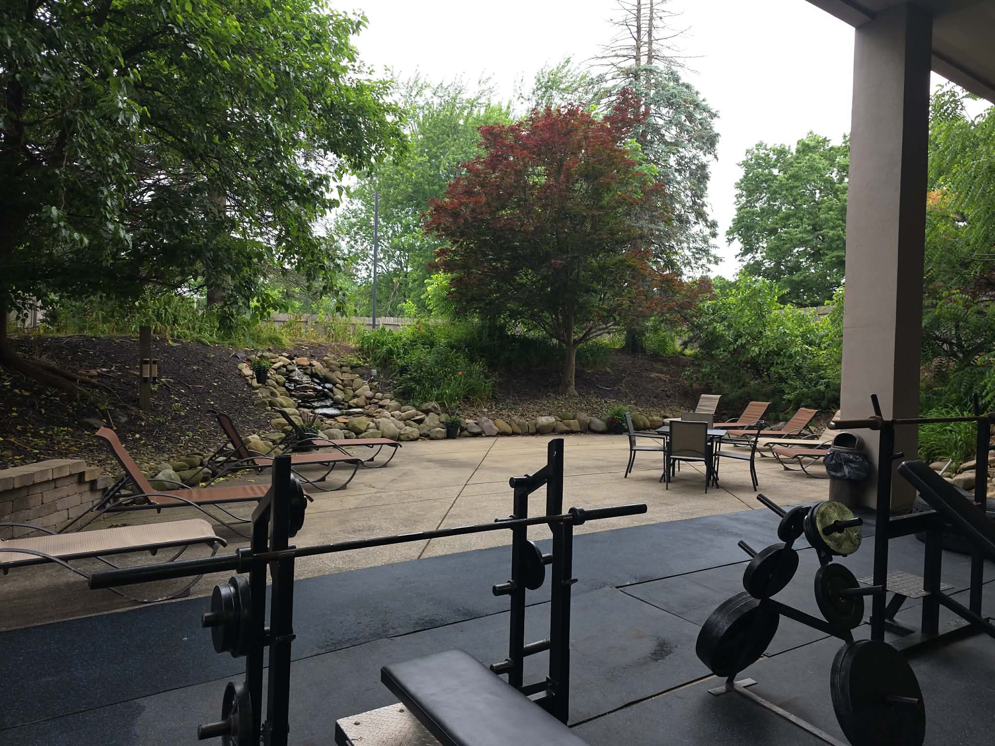 Outdoor patio with waterfall feature and lounge seating at Cleveland Fitness Club